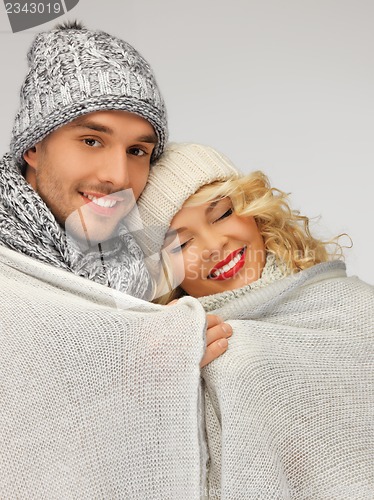 Image of family couple under warm blanket