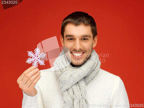 Image of man in warm sweater and scarf with snowflake