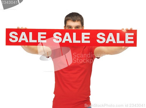 Image of man holding sale sign