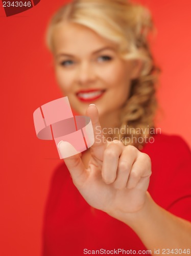 Image of woman in red dress pressing virtual button