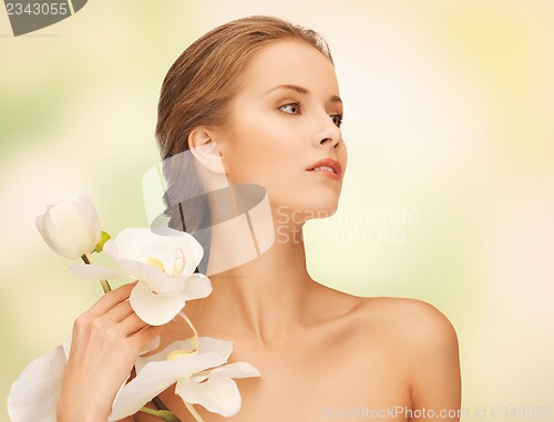 Image of lovely woman with orchid flower