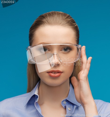 Image of businesswoman in protective glasses