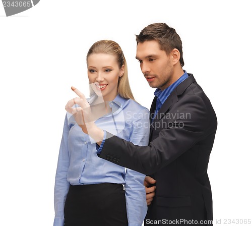 Image of man and woman working with something imaginary