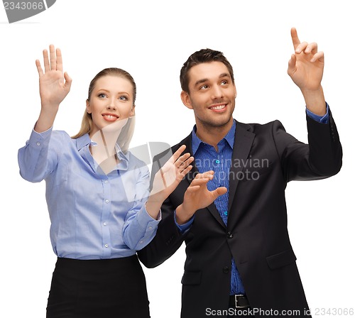 Image of man and woman working with something imaginary