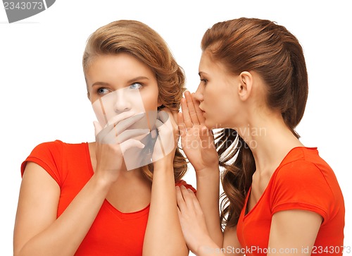 Image of two talking teenage girls in red t-shirts