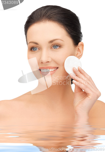 Image of beautiful woman with cotton pad in water