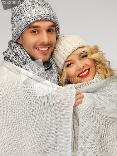 Image of family couple under warm blanket