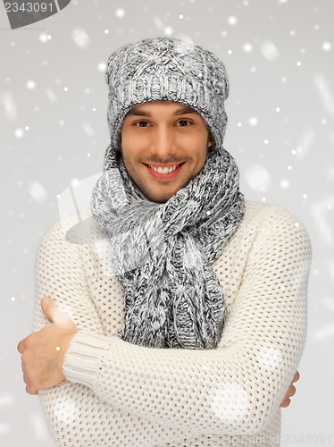 Image of handsome man in warm sweater, hat and scarf