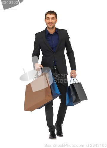 Image of handsome man in suit with shopping bags