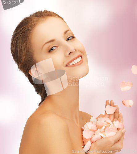 Image of beautiful woman with rose petals