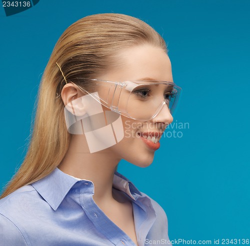 Image of businesswoman in protective glasses