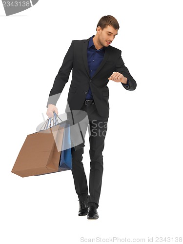 Image of handsome man in suit with shopping bags