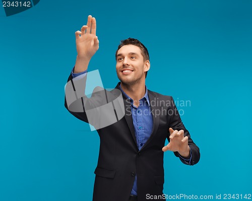 Image of man in suit working with something imaginary