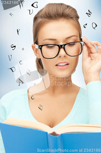 Image of calm and serious woman with book