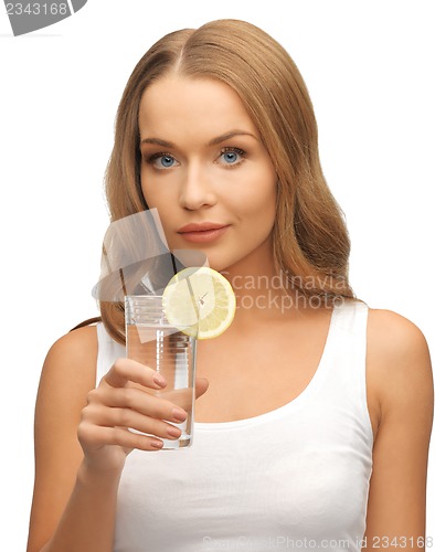 Image of woman with lemon slice on glass of water