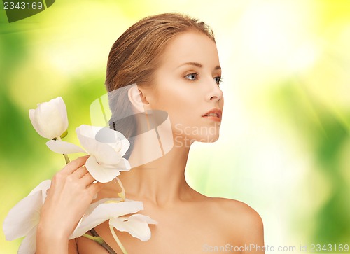Image of beautiful woman with orchid flower
