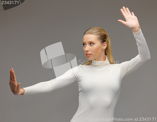 Image of woman working with something imaginary