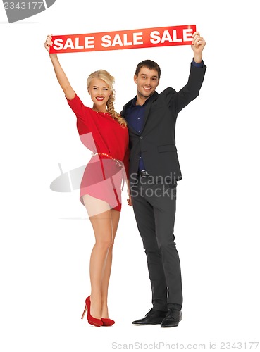 Image of man and woman with sale sign