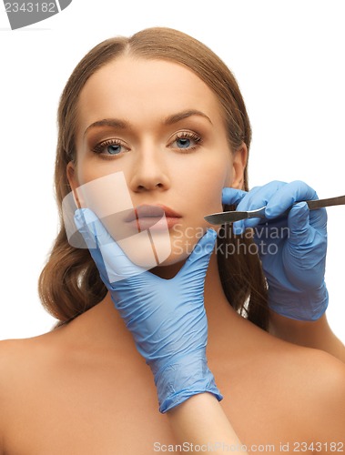 Image of woman face and beautician hands