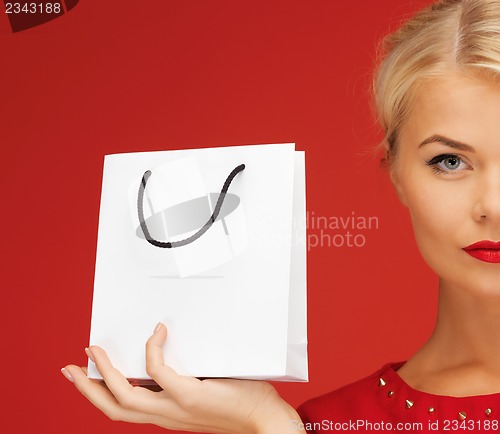 Image of lovely woman in red dress with shopping bag