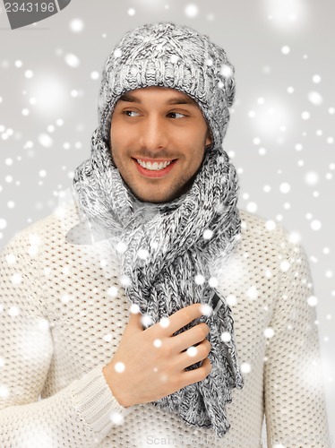 Image of handsome man in warm sweater, hat and scarf