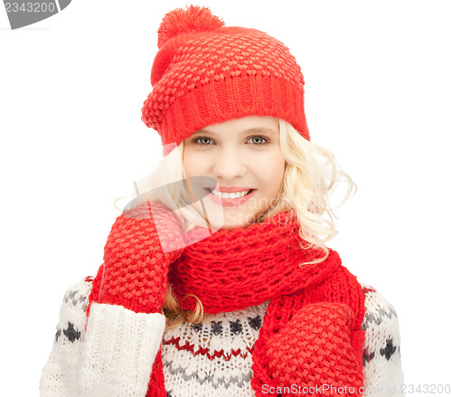 Image of beautiful woman in hat, muffler and mittens