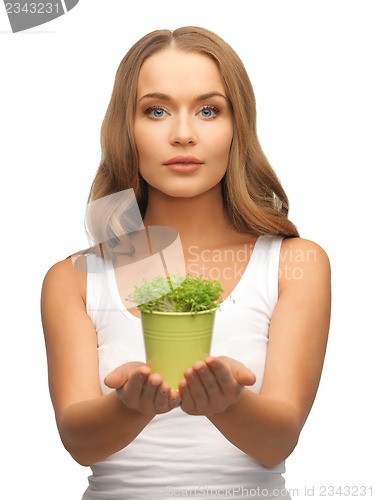 Image of woman with green grass in pot