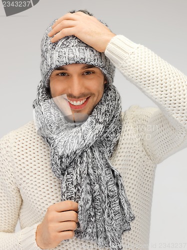 Image of handsome man in warm sweater, hat and scarf