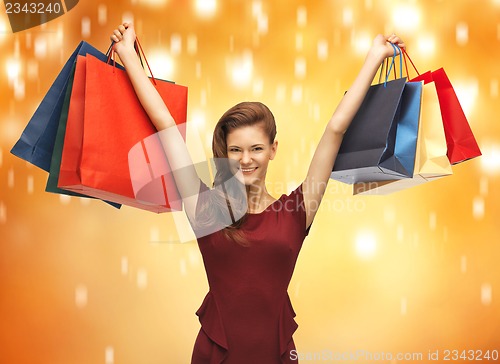 Image of teenage girl in red dress with shopping bags