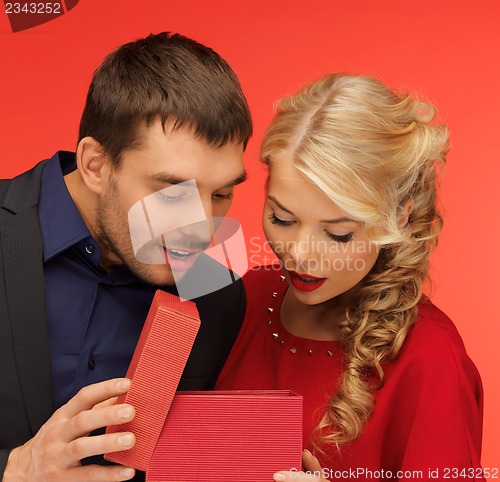 Image of man and woman looking inside the gift box