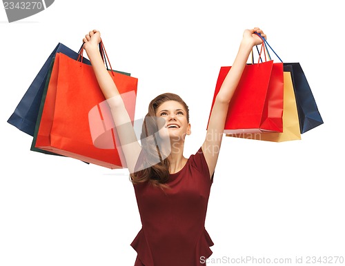 Image of teenage girl in red dress with shopping bags