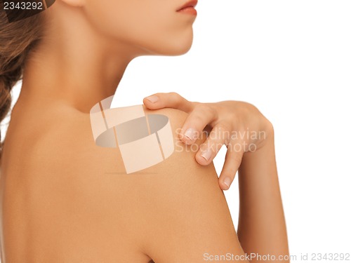 Image of woman's hand and shoulder