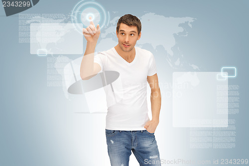 Image of handsome man working with touch screen