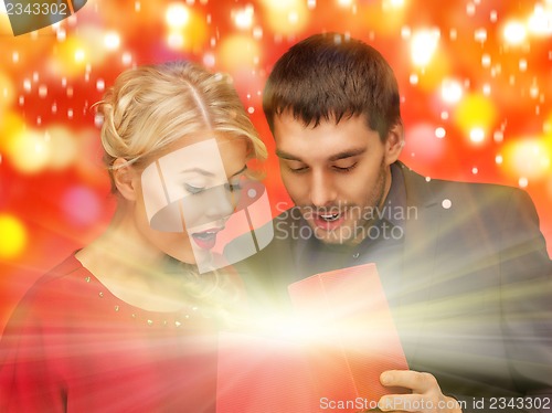 Image of man and woman looking inside the gift box