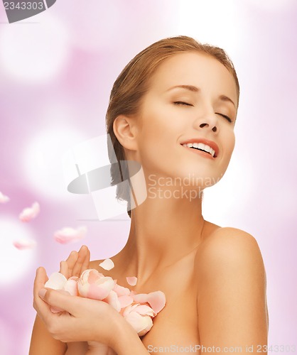 Image of beautiful woman with rose petals