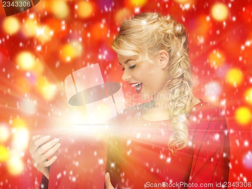 Image of lovely woman in red dress with opened gift box