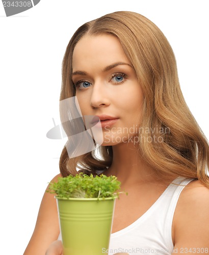 Image of woman with green grass in pot