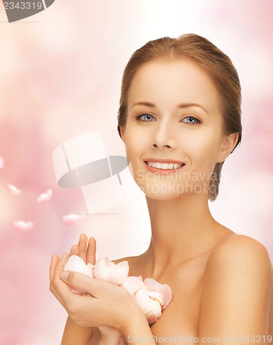 Image of beautiful woman with rose petals