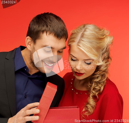 Image of man and woman looking inside the gift box