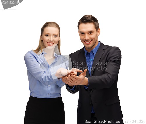 Image of man and woman showing something on the palms