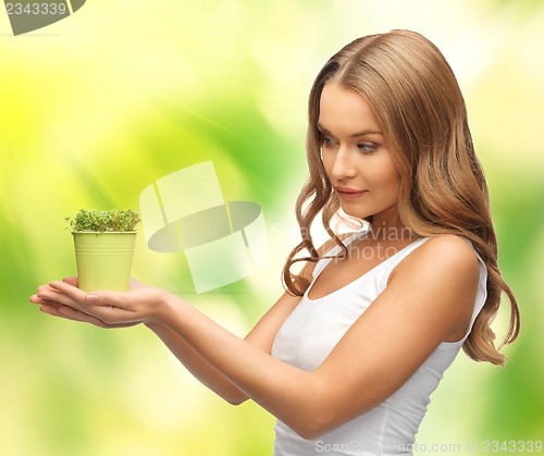 Image of woman with green grass in pot