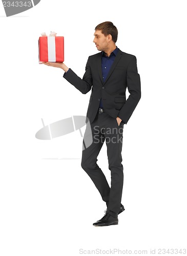 Image of handsome man in suit with a gift box