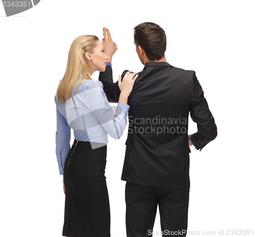 Image of man and woman working with something imaginary