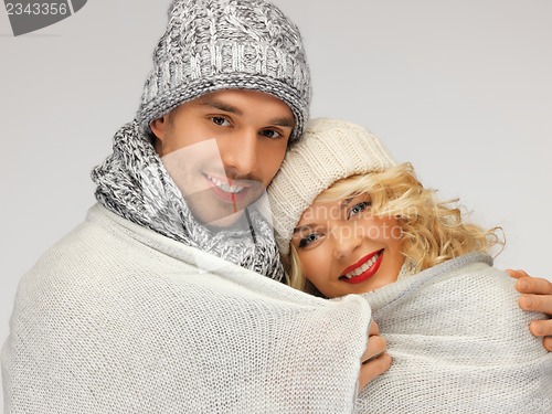 Image of family couple under warm blanket