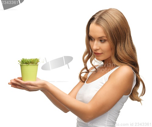 Image of woman with green grass in pot