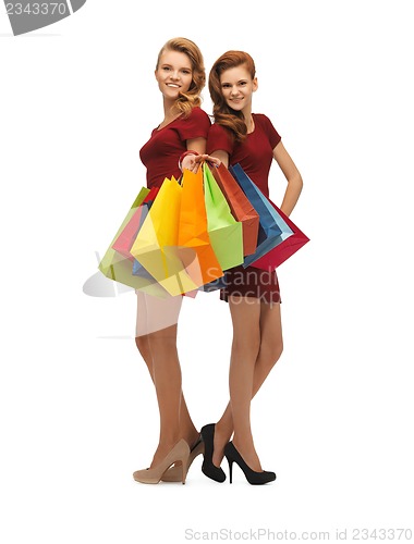 Image of teenage girls in red dresses with shopping bags