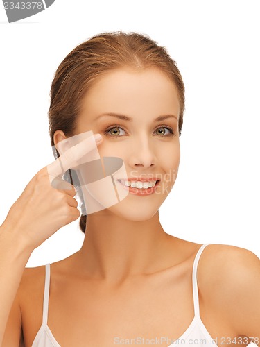 Image of beautiful woman pointing to eye