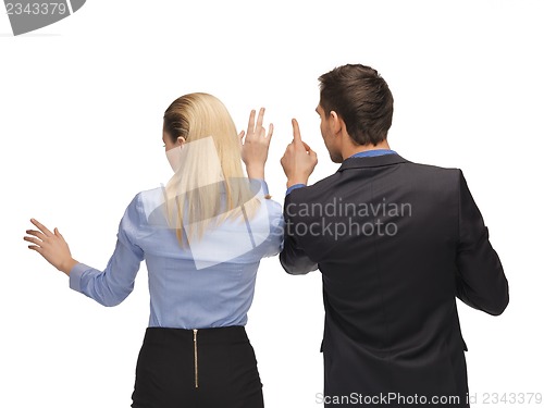 Image of man and woman working with something imaginary