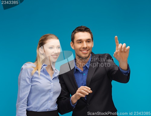 Image of man and woman working with something imaginary