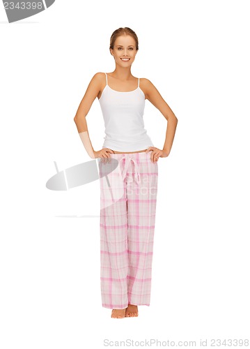 Image of happy and smiling woman in cotton pajamas